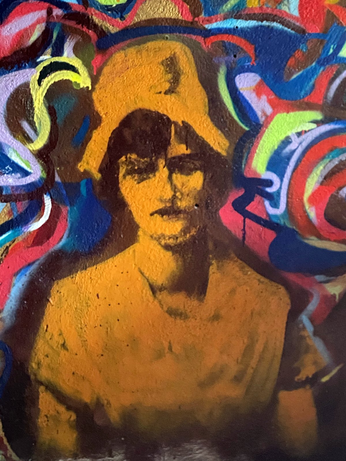 Grandmother mural in sepia — photo-real portrait inside spray abstraction